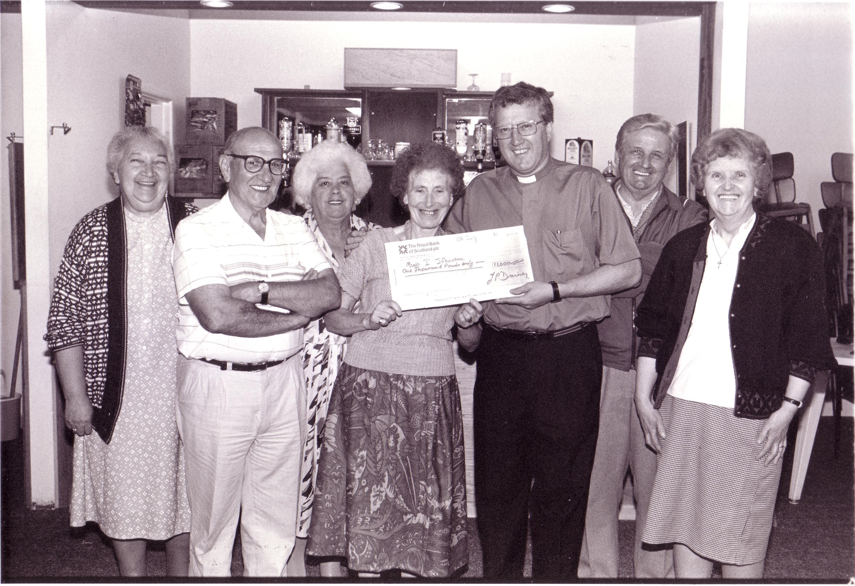 Fr Terry Drainey presenting a parish cheque